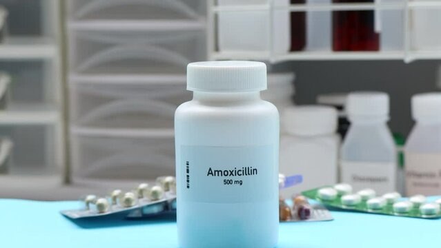 Amoxicillin pill in white bottle, pill stock, medical or pharmacy concept