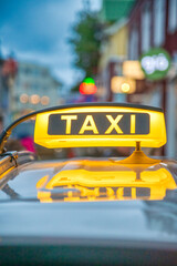 Yellow Taxi sign over a car in Reykjavik, Iceland
