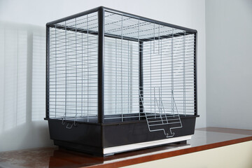 A large empty room cage for a parrot.