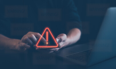 Man using smartphone with triangle caution warning sign for notification error and maintenance concept. Problem and hacking data, cyber crime, cyber security