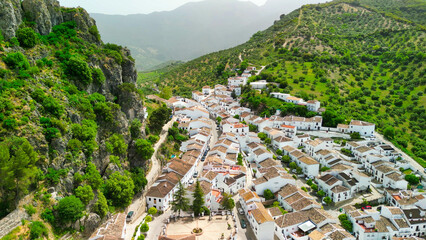 Zahara de la Sierra, Andalusia. Aerial view of whitewashed houses sporting rust-tiled roofs and wrought-iron window bars - obrazy, fototapety, plakaty