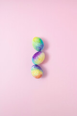 Fototapeta na wymiar Beautiful colorful eggs on pink background. Minimal food concept.