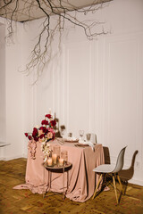 Romantic date. Luxury candlelight dinner table setup for couple on Valentine's day. Table setting in restaurant. Location decoration red flowers and decor with candles for surprise marriage proposal.