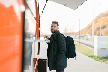 Fototapeta na wymiar Portrait of man choosing fast food in food truck in street. Meal food industry and streetfood concept