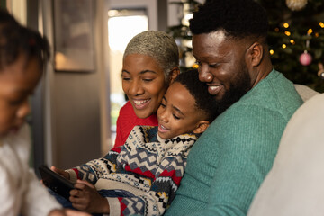 Family using a smartphone at Christmas time together