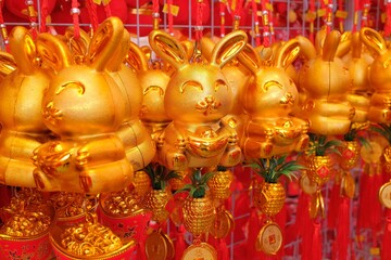 Row of golden rabbit trinkets and ornaments for sale at a bazaar, Chinese New Year of the Rabbit