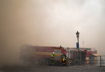 Close up of firemen in action in a city center.