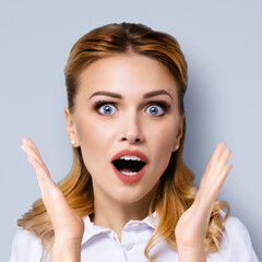 Wow. Face portrait excited surprised, shocked happy woman with wide open mouth and eyes, raised up hands, isolated grey gray background. Unbelievable sales offers, ad concept. Square.