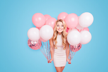 Portrait of positive elegant girlfriend in white dress having many white air balloons around her...