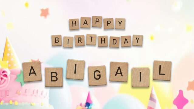 Happy Birthday Abigail card with wooden tiles text. Girls birthday card with colorful background.