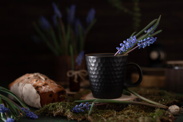 A bouquet of purple muscari and a cup for a warm drink