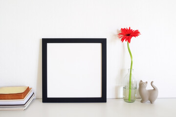 blank frame picture with flower on table
