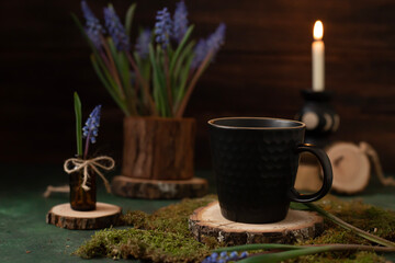 A bouquet of purple muscari and a cup for a warm drink