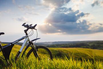 Naklejka premium Bicycle on the spring meadow. Travel, sport, lifestyle concept