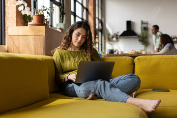 Female student using a laptop for study at home