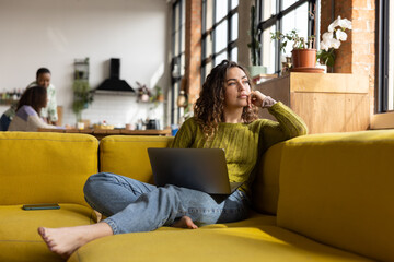Young adult female working from home on a laptop
