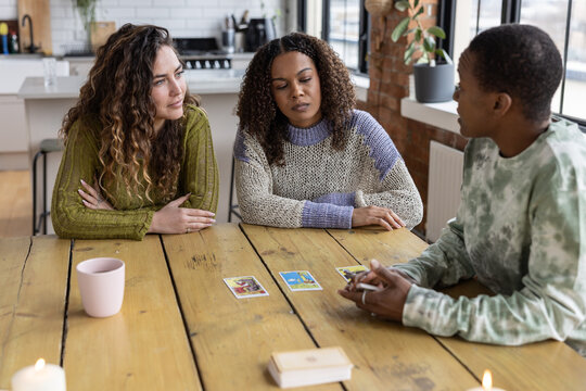 Females Friends Reading Tarot cards on Kitchen table