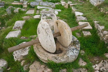 stone millstones, an ancient device for grinding grain - obrazy, fototapety, plakaty