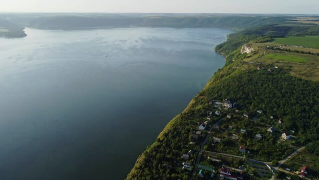 Aerial view flooded village of Bakota and the reservoir of Dniester River in Ukraine. Rocky green hills, part of National park, Podilski Tovtry. Wonderful large lake formed by overflow of river