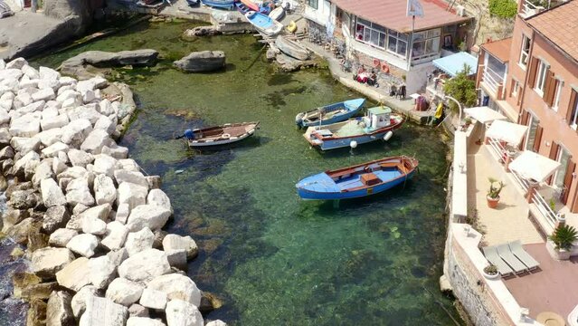 Aerial view of the seaside village of Marechiaro which is located in the Posillipo district of Naples, Italy. There are small boats anchored in the artificial harbour.