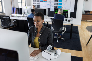 Coder in an office with VR headset on desk