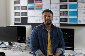 Portrait of young male coder in an office