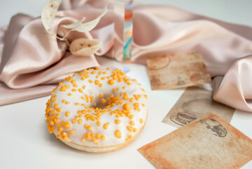 Sweet fresh donut in white glaze on the table