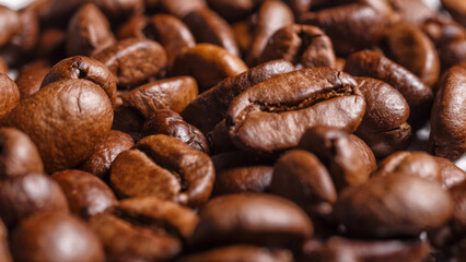 Freshly roasted coffee beans background.Dark roasted coffee beans with scoop on wooden background.