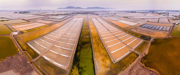 Long Dien sald field, Ba Ria Vung Tau province, Vietnam in salt making season in the April 2023. The salt field under the shimmering sunrise