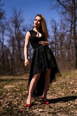 Vertical shot of an attractive Caucasian female posing in the forest