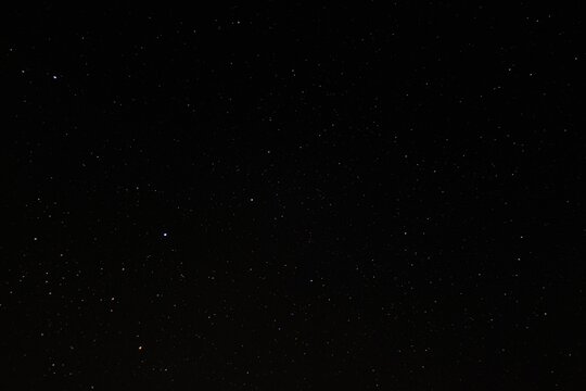 Image of a night skyline featuring a dark blue sky with stars twinkling in the background