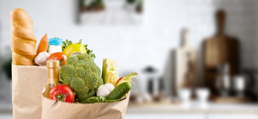 Shopping bags with fresh groceries on background