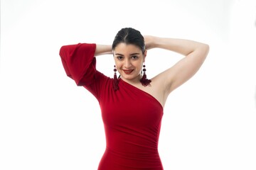 Happy attractive female in red dress posing on white background