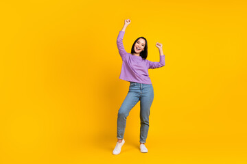 Fototapeta na wymiar Full size photo of satisfied girl with bob hairdo dressed violet shirt denim pants dancing having fun isolated on yellow color background