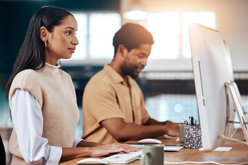 Business woman, computer and coworking office for research, planning and online web project. Focused female employee typing on desktop technology for email, network information and administration