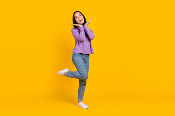 Fototapeta na wymiar Full length photo of excited pretty woman wear violet shirt arms face smiling empty space isolated yellow color background