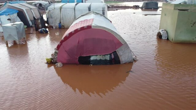 Top view of a Syrian refugee camp. Syrian refugee tents flooded due to heavy rains.