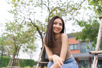 Happy feeling of Beautiful Young Woman smiling outdoor in sunlight. Pretty attractive face of female and beautiful smile. She is positive thinking and successful.