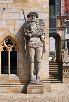 Smiling medieval Roland knight statue at the gothic town hall in the old city of Halberstadt in Germany