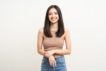 Beautiful smiling happy young asian woman age around 25 in brown shirt. Charming female lady standing pose on isolated white background. Asian cute people looking camera confident with white backdrop.