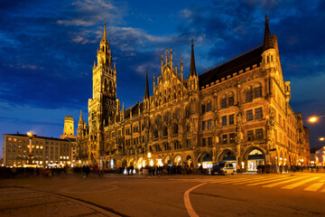 Fototapeta na wymiar Marienplatz central square illuminated at night with New Town Hall (Neues Rathaus) - a famous tourist attraction. Munich, Germany