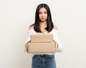 Upset confused bad emotional asian woman with parcel cardboard. Unhappy stressed female receive wrong product from delivery man.