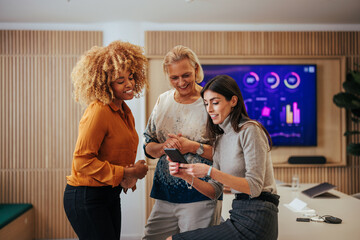 Joyful businesswomen bonding in office.