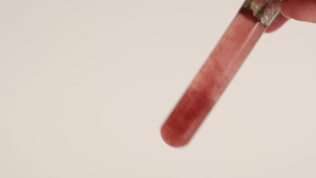 Haematococcus pluvialis in test tube with clear liquid. Astaxanthin, protection of UV-radiation, antioxidant. Abstract body care cosmetics