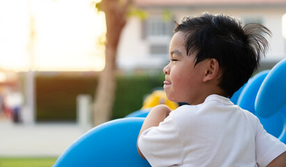 Funny cute happy baby playing on the playground. The emotion of happiness.
