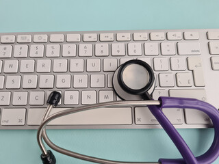 Computer keyboard with medical stethoscope closeup