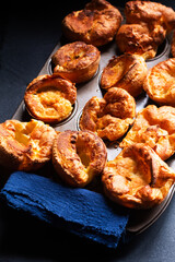 Food Concept Homemade spot focus Yorkshire pudding on black background with copy space