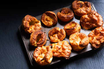 Food Concept Homemade spot focus Yorkshire pudding on black background with copy space