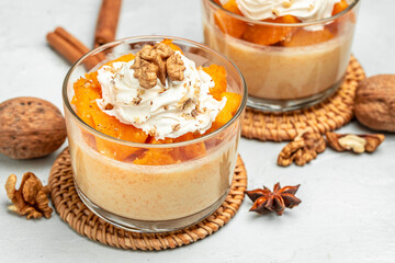 Layered pumpkin and cream cheese dessert on a light background. banner, menu, recipe place for text, top view