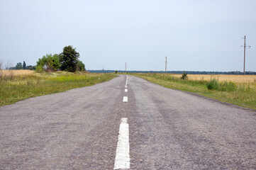 Fototapeta na wymiar Old motor road in the countryside in summer